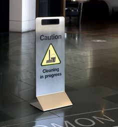 a caution sign on the floor in an office building