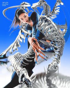 the woman is posing in front of a silver dragon sculpture with her hands on her hips