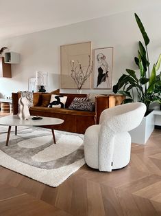 a living room filled with furniture and plants