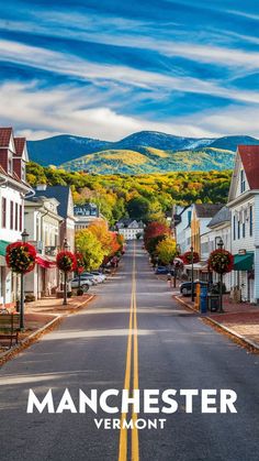 an empty street with houses and mountains in the background that says manchester vermont on it