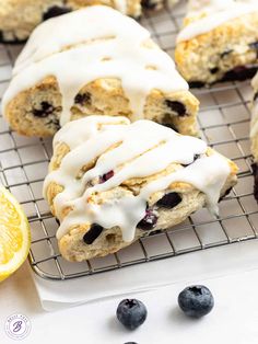 lemon blueberry scones with icing on a cooling rack