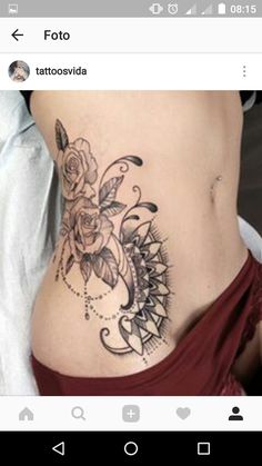 a woman's stomach with tattoos on it