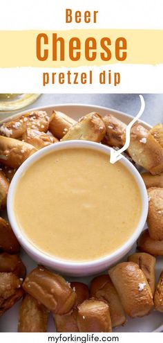 a white plate topped with cheese pretzels next to a bowl of dipping sauce