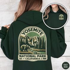 Show off your love of the beautiful Yosemite Falls, with our Yosemite National Park Hoodie! This super comfy hooded sweatshirt makes a great family vacation trip gift and is all about embracing the great outdoors! It features a custom design that showcases the beauty of the native black bears in Yosemite Valley and the High Sierra complete with the majestic Lower Yosemite Falls! The Gildan 18500 50/50 blend fabric has that comfy, lived-in feel, that's like a hug every time you put it on! Now you Fall Hiking Hoodie With Kangaroo Pocket, Fall Hiking Sweatshirt With Kangaroo Pocket, Fall Fleece Hoodie For Hiking, Winter Camping Hoodie With Letter Print, Fall Camping Hoodie, Fall Graphic Print Hoodie For Outdoor Activities, Graphic Print Hoodie For Fall Outdoor Activities, Fall Hiking Sweatshirt With Drawstring Hood, Hooded Sweatshirt With Letter Print For Hiking