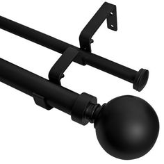 a black ball mounted to the side of a metal pole with two brackets on it