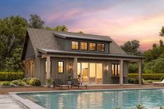 a house with a pool in front of it and a covered patio next to it