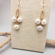 Three stones dangle from brass chain. Great for all ages, these simple earrings are easily dressed up or down. All pieces will be packaged together in a cotton filled jewelry box unless otherwise specified. Please let us know if your order is a gift and we will gladly include a handwritten note and complimentary gift wrap. Dainty Handmade Gold Pearl Earrings, Brass Pearl Drop Jewelry Gift, Pearl Drop Brass Jewelry For Gift, Brass Round Jewelry With Pearl Drop, Round Pearl Drop Brass Jewelry, Round Brass Jewelry With Pearl Drop, Minimalist Brass Wedding Jewelry, Gold Dangle Pearl Earrings As Gift, Handmade Dainty Gold-plated Pearl Earrings