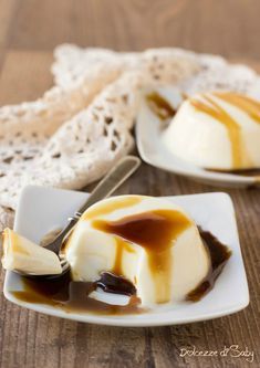 two small white plates filled with dessert on top of a wooden table