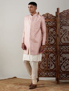 Vastramay Men's Peach Sequined Indo Western Sherwani With Kurta Pyjama Set Make a statement at weddings and festive occasions with this elegant Indo Western Sherwani set from VASTRAMAY. Crafted in a peach hue with sequin detailing, this outfit exudes traditional charm with a modern twist. The set includes a Sherwani and matching Kurta Pyjama. Features: Sequined detailing for a stylish look Modern Indo Western design Includes Sherwani and Kurta Pyjama Perfect for weddings and festive occasions Sp Festive Pink Kurta With Naqshi Details, Pink Traditional Wear With Naqshi For Festivals, Fitted Pink Sherwani With Cutdana, Pink Fitted Sherwani With Cutdana, Festive Pink Formal Traditional Wear, Pink Straight Kurta Bandhgala For Festivals, Festive Pink Nehru Jacket Straight Kurta, Pink Bandhgala With Zari Work For Eid, Transitional Pink Sherwani Straight Kurta