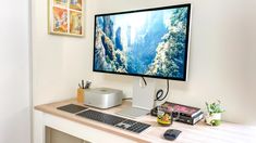 a desktop computer monitor sitting on top of a desk next to a keyboard and mouse