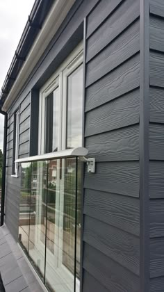 an image of a house with siding on the outside and windows in the front side