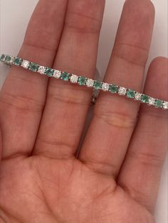 6.90 Carat Natural Emerald and Diamond Bracelet G SI 14K White Gold 7'' 100% Natural Diamonds and Emeralds 6.90 CTW (Diamonds - 2.55CT, Emeralds - 4.35CT) Dia Color: G-H Dia Clarity: SI 14K White Gold, prong style 7 inches in length B5882-6WDE ALL OUR ITEMS ARE AVAILABLE TO BE ORDERED IN 14K WHITE, ROSE OR YELLOW GOLD UPON REQUEST. All Chains of Pendants and Necklaces Can be Requested in 16'' or 18'' Length. . This item is proudly handcrafted in the USA. Perfect gift on any occasion. This Item h Green Tennis Bracelet With Prong Setting For Anniversary, Hallmarked Tennis Bracelet For Anniversary, Classic Green Tennis Bracelet For Anniversary, Formal Fine Jewelry Hallmarked Tennis Bracelet, Classic Green Tennis Bracelet For Formal Occasions, Green Classic Tennis Bracelet For Formal Occasions, Aaa Quality Diamond Bracelet For Formal Occasions, Emerald Bracelet, Timeless Accessories