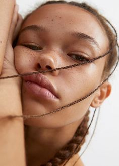 a woman with braids on her head and eyes