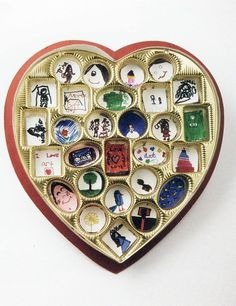 a heart shaped brooch with many different pictures on it