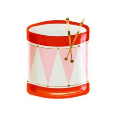 a red and white clock sitting on top of a plastic cup filled with candy canes