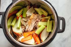 an overhead view of a pot full of vegetables and meat, including celery