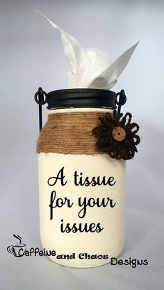 a mason jar with a white tissue dispenser and brown ribbon on it