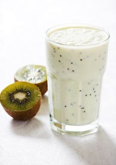 a kiwi fruit and milkshake on a table