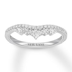 a white gold ring with three diamonds on the band and an inscription that says veil lane