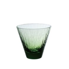 a green glass vase sitting on top of a white table