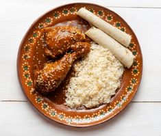 a brown plate topped with rice and chicken