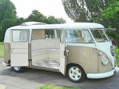 an old vw bus is parked on the side of the road