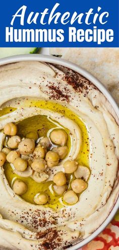 hummus in a white bowl with olives on top