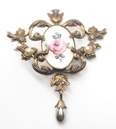 Guillouche pink rose flower white enamel Art Nouveau style faux pearl vintage brooch. Fair vintage condition with small signs of normal vintage wear. Enamel is smooth with no signs of crazing or chips. There is a small amount of discoloration under the seal around the edge as seen in pictures. Small amount of wear on the surface of one pearl accent. Brooch measures 2 and 1/4 of an inch tall and 2 inches wide. Vintage Pink Collectible Brooches, Vintage Rose Gold Brooches For Wedding, Vintage Rose Gold Wedding Brooches, Vintage Pink Enamel Brooches, Vintage Rose Brooch Jewelry, Vintage Rose Brooch, Vintage Rose Flower Brooch, Vintage Rose Jewelry With Brooch, Vintage Rose-colored Flower-shaped Jewelry