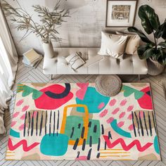 an aerial view of a living room with couches, rugs and paintings on the wall