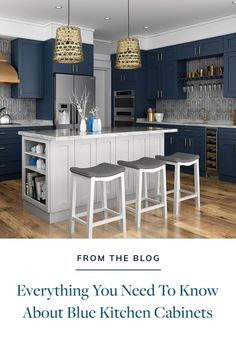 a kitchen with blue cabinets and white stools in front of the counter top is an island that has two bar stools on it