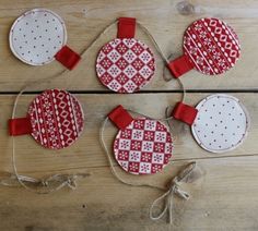 red and white ornaments hanging from string on wooden floor