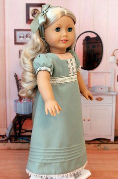 a doll with blonde hair wearing a green dress