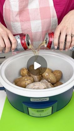 a person pouring something into a pot with rocks in it