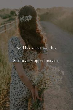 a woman holding flowers in her hand with the words and her secret was this she never stopped praying