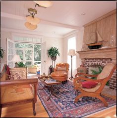 a living room filled with furniture and a fire place in front of a brick fireplace