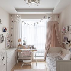 a bedroom with a bed, desk and curtains in it's windowsills