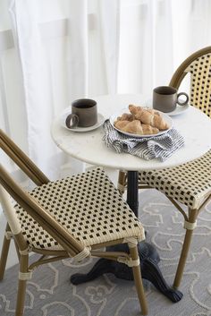 two chairs and a table with food on it