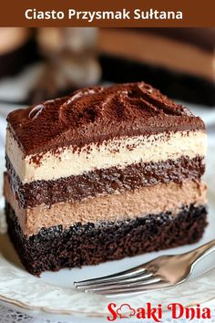 a piece of cake on a white plate with a fork in front of it and the words ciasto przymak suttana above it