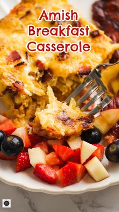 a close up of food on a plate with a fork and text that reads amish breakfast casserole