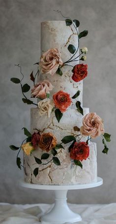 a three tiered wedding cake with flowers on it