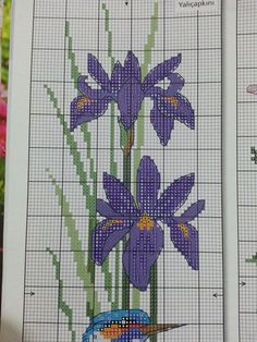 two cross stitch pictures with purple flowers and blue bird in the middle one has green leaves on it