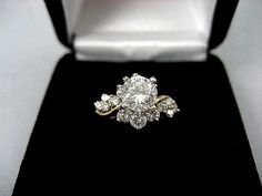 a diamond ring sitting on top of a velvet box