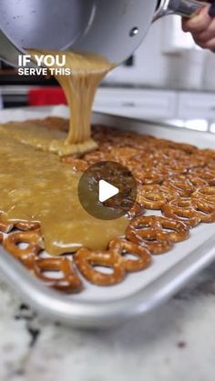 someone is pouring caramel sauce on pretzels in a pan with the words if you serve this