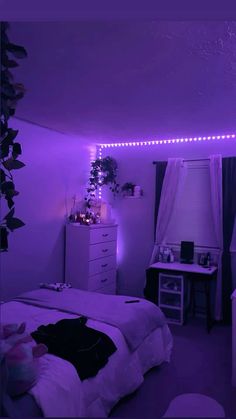 a bedroom with purple lights on the ceiling