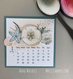 a calendar with sea shells and starfish on it