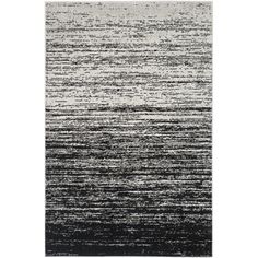 a black and white rug with stripes on the bottom, in shades of grays