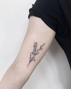 a woman's arm with a flower tattoo on the left side of her arm