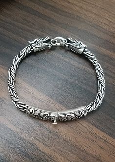 Dragons! Solid 925 Sterling Silver Bracelet | Byzantine Chain Dragons Bracelet for Men This bracelet is made of Solid 925 Sterling Silver. Handcrafted by our well experienced artisans. It is a sturdy, flexible and nice finish bracelet with a detailed designed end caps and strong box clasp closure for ease in wearing.  It has oxidized finish, which brings out the details of the design, so much goodness to see! Details; * Metal : 925 Sterling Silver * Weight. : 40 grams (approx.) * Length : 8.5 inch * Measurement : 5.5mm (thick)  * Closure : Box Clasp Marked 925 for authenticity. Handmade with Love; - All items are hand-crafted with love in our happy studio. - We use highest quality proven materials and give attention to every detail. - We also take pride in excellent customer service and wa Byzantine Chain, Dragon Bracelet, Artisan Bracelets, Mens Bracelet Silver, Silver Chain Style, Box Clasp, Bracelet For Men, Sterling Silver Bracelet, Chains For Men