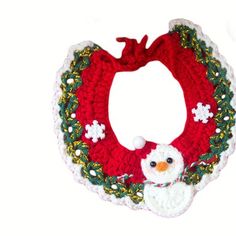 a crocheted christmas wreath with a snowman on it