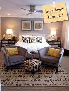 a bed room with a neatly made bed and two zebra print ottomans on the floor